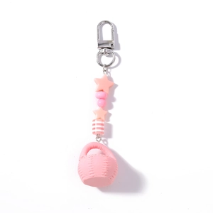 Detail of pink beaded keychain with silver star charms and a miniature woven basket pendant