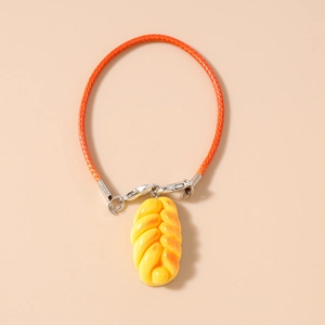 Macro detail of realistic bread charm with orange braided strap and silver metal clasp
