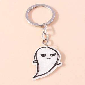 Close-up of cute ghost keychain with marble pattern and silver metal ring and chain