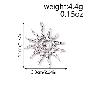 Detail view of antique silver sun pendant with spiral center and dimension markings