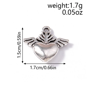 Detail showing dimensions of vintage silver winged heart pendant for DIY jewelry making