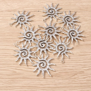 Detailed set of 10 antique silver sun spiral pendants for DIY jewelry crafting and accessories