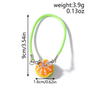 Detailed view of the 3D orange charm with size measurements and green braided phone strap