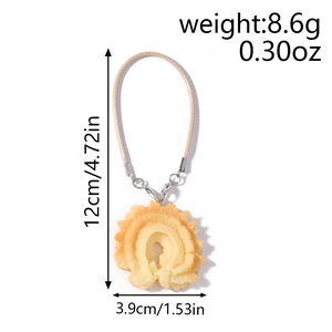 Detail of waffle cookie pendant with dimensions 3.9cm width and 12cm length for phone bags