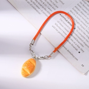 Close-up of a realistic hot dog bun pendant with orange woven strap and silver clasp