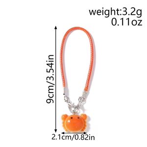 Detailed view of an orange crab charm pendant with specific size and weight dimensions