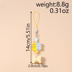 Detail showing cartoon bee, blue star, and pink bow charms on a 14cm phone chain