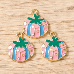 Close-up of colorful enamel fruit pendants with gold rings for DIY jewelry making