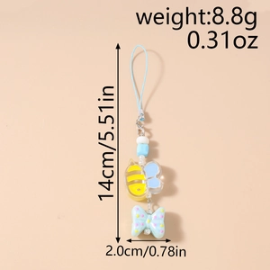Detail view of cartoon bee phone strap with blue polka dot bow and size measurements