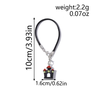 Detailed view of Halloween castle charm with black and red enamel and metal lobster clasp