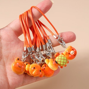 Cute orange braided resin animal phone straps held in hand for size display