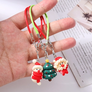 Detail of Christmas tree, Santa, and snowman charms with colorful braided lanyards