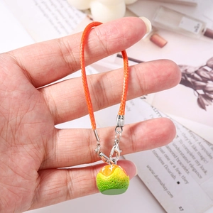 Close-up of a realistic citrus orange fruit pendant with an orange woven strap charm