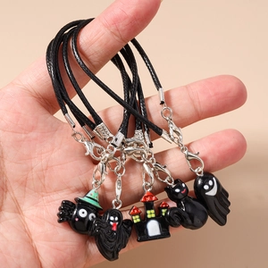 Close-up of Halloween charms including spider, ghost, and castle for phone straps