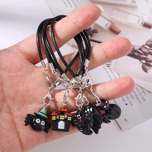 Detail of Halloween phone charms featuring ghost, spider, and castle with lobster clasps
