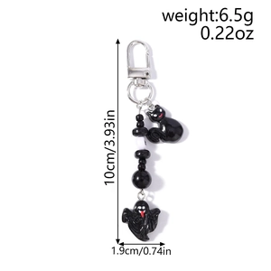 Detailed view of Halloween cat and ghost keychain charms with beads and size markings