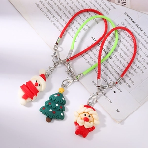 Close-up of Christmas snowman and Santa charms with colorful braided lanyards and silver hooks