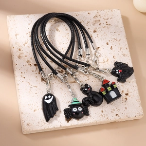 Five Halloween phone charms set featuring spider, ghost, and castle on a stone tray