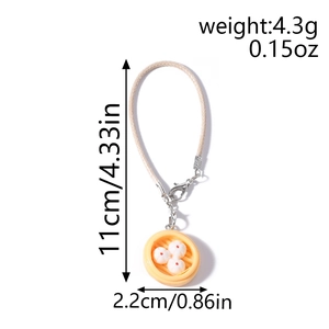Detailed view of dumpling steamer charm with dimensions 11cm length and 2.2cm diameter