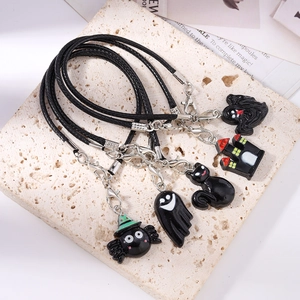 Halloween jewelry set with spider, ghost, cat, and castle charms on black cords