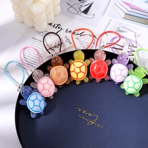 Colorful resin turtle phone charms with braided straps in seven vibrant jelly finish tones