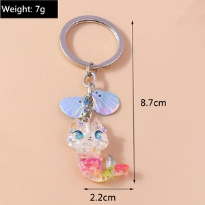 Detail view of a cat mermaid keychain with purple sequins shells and iridescent resin body