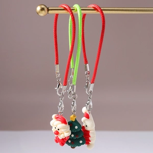 Detailed view of Christmas Santa, tree, and snowman charms with woven cords and clasps