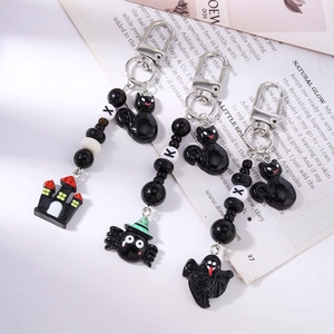 Three-piece Halloween beaded keychain set with spooky ghost, castle, and monster charms