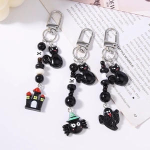 Halloween beaded keychain set featuring black cat, haunted castle, and spider charms