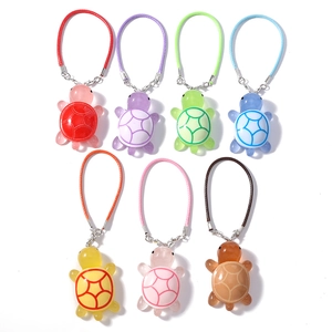 Set of 7 colorful resin sea turtle phone charms with matching woven cords for bags