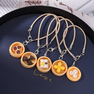 Realistic miniature dim sum charms featuring baozi and siumai with woven leather cord
