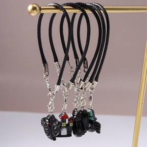 Detail of Halloween phone charms set including ghost, castle and black cat pendants