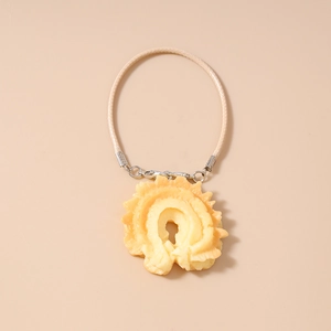 Detail of creative waffle resin pendant with woven cord and silver metal lobster clasp