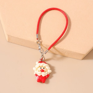 Close-up of a Santa Claus pendant charm with red woven strap and lobster clasp