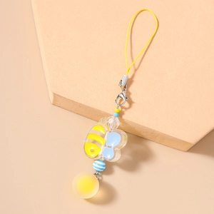 Detail of yellow bee acrylic charm with striped beads and matching strap for phone or bag