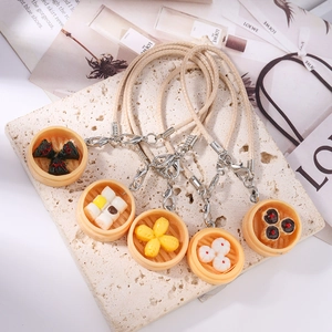 Detailed close-up of realistic dim sum charms including buns and dumplings on stone surface