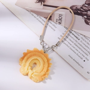 Detail of realistic waffle cookie charm with braided rope and metal lobster clasp