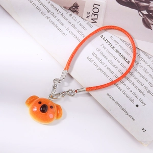 Close-up of cute orange koala charm with woven rope and silver lobster clasp detail