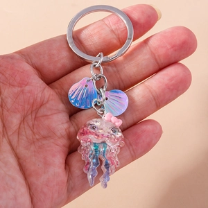 Pink resin jellyfish keychain with glitter shell charms and a cute bow on a metal ring