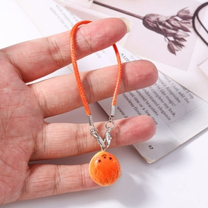 Detail of handmade orange woven phone strap with resin charm and silver lobster clasp