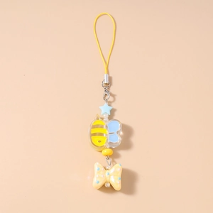 Close-up of yellow braided lanyard with a cartoon bee pendant and a blue star charm
