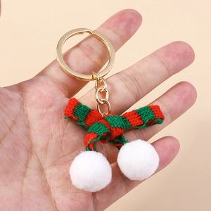 Christmas bow plush pom-pom keychain with red and green stripes in gold metal hardware