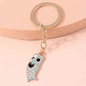 Japanese style light blue koi carp streamer keychain with gold metal ring on pink stand