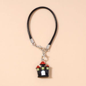 Close-up of Halloween castle charm with black braided cord and silver lobster clasps