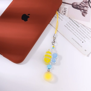 Close-up of a cartoon bee and blue butterfly acrylic phone charm with striped beads
