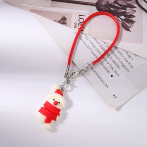 Detail of Christmas snowman charm with red scarf and woven lanyard for phone or bag