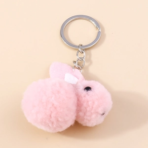 Detail view of pink plush bunny keychain with fluffy fur texture and silver metal ring