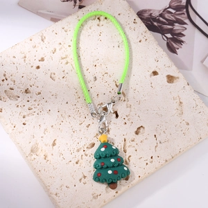 Detailed view of festive green resin Christmas tree charm with green woven lanyard strap