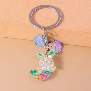 Detailed macro view of colorful gradient resin rabbit-fish keychain with purple shells