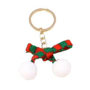 Christmas plush keychain with red and green knit bow and white fuzzy balls on gold ring